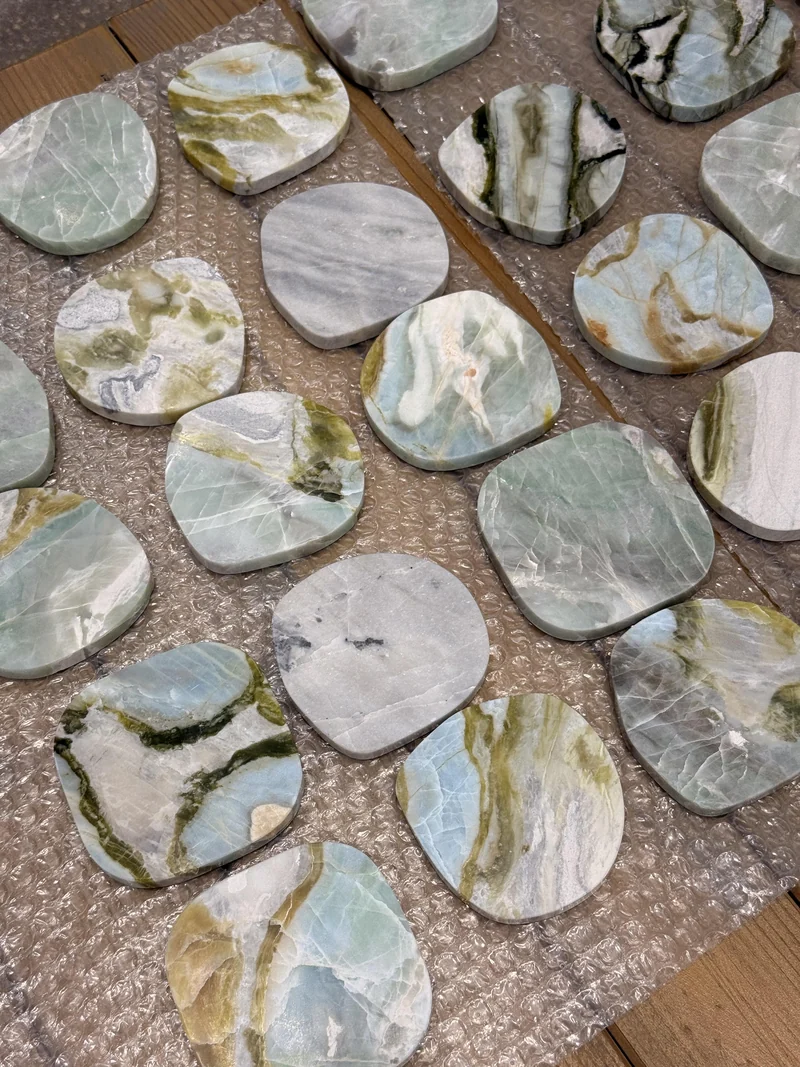 Assorted round and rounded-square stone pieces with varied vein patterns