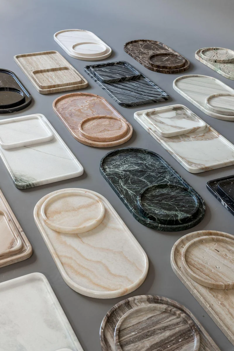 Stone trays and small dishes in contrasting light and dark colours