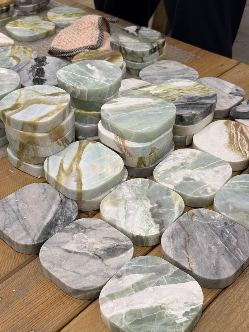 Round and square stone pieces stacked together on a workshop table