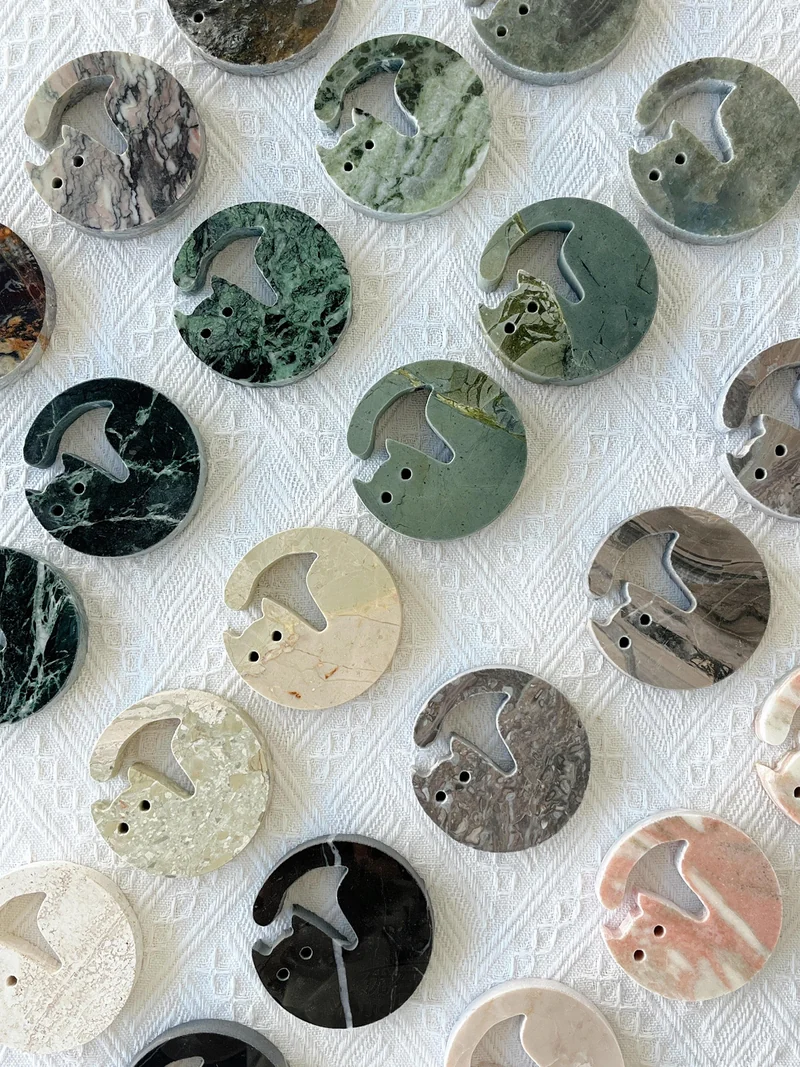 Round stone profiles with large cut-outs and small holes on a work surface
