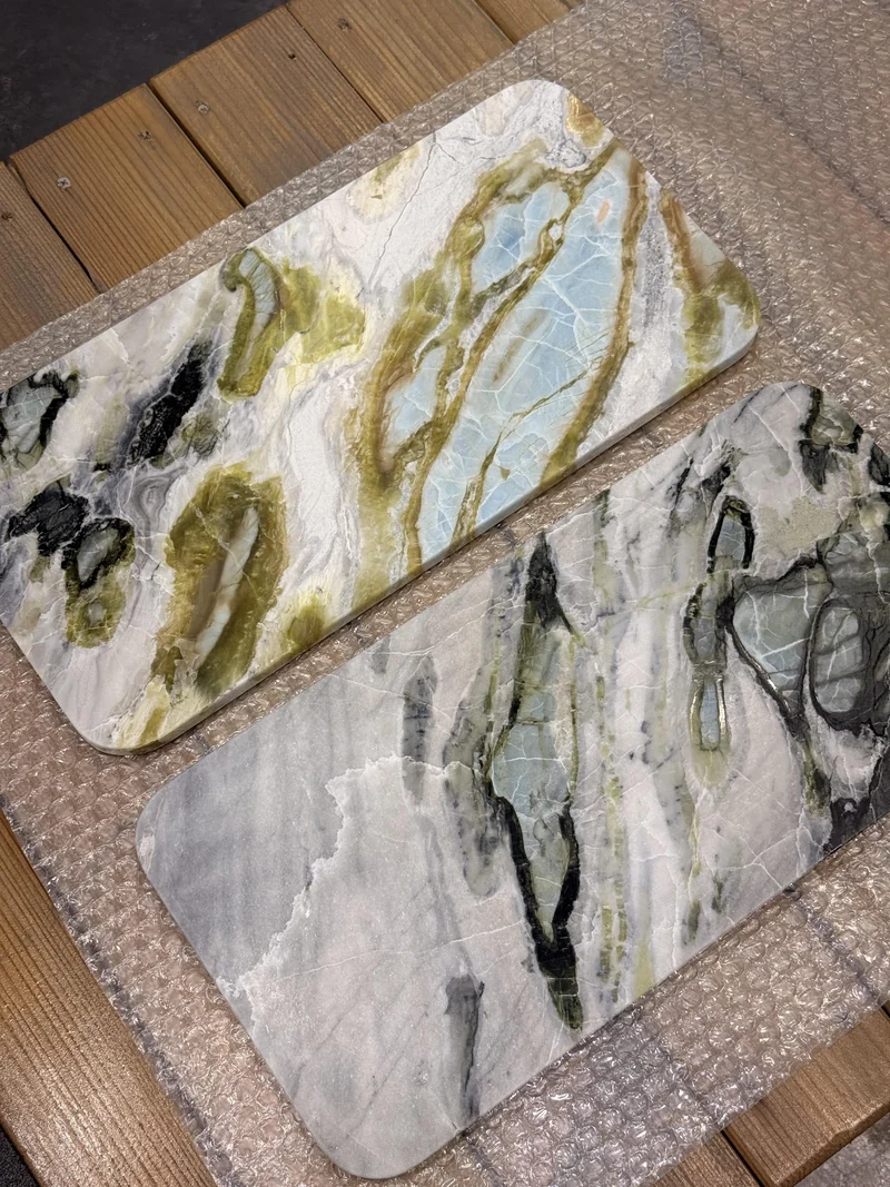 Two rounded rectangular stone pieces resting on protective bubble wrap