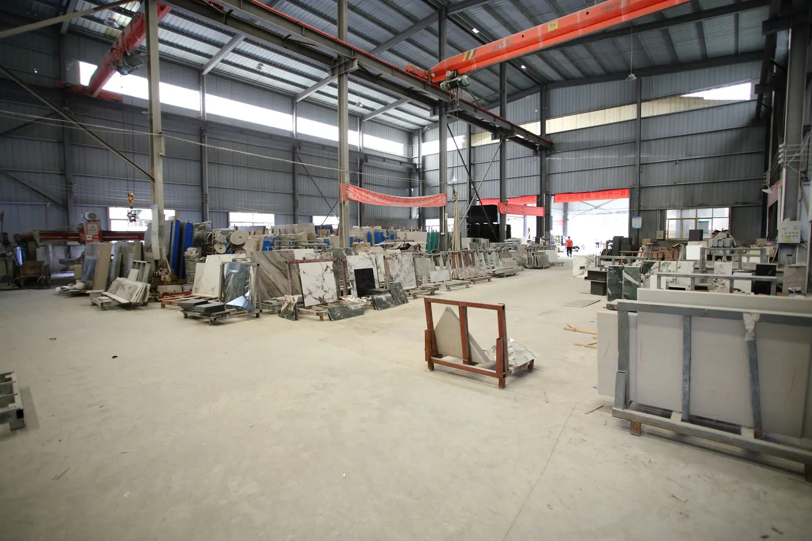 DeHong Stone factory floor with stone slabs and handling frames