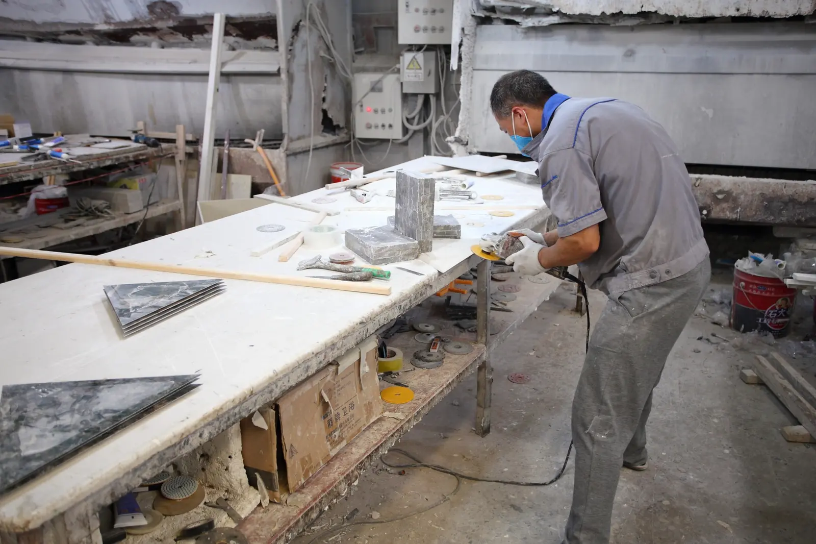 Worker hand-finishing stone components