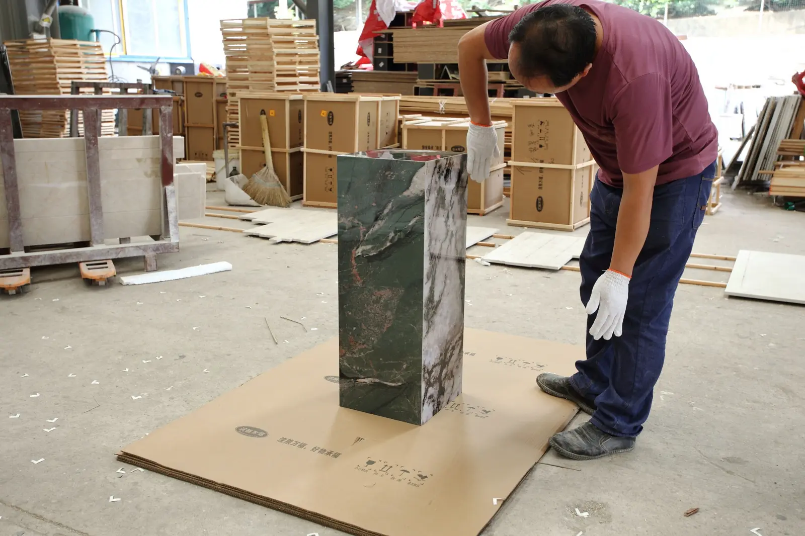 Worker checking a finished stone pedestal