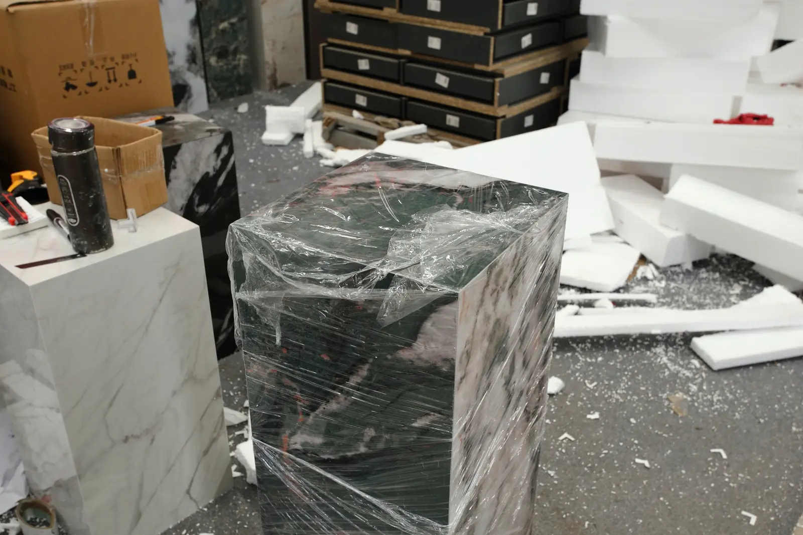 Stone pedestal protected with stretch film