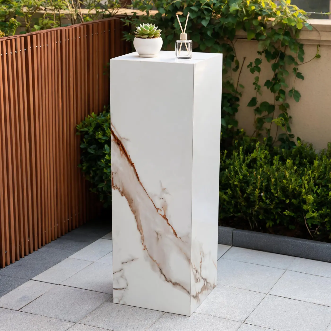 Calacatta Gold pedestal in a garden setting