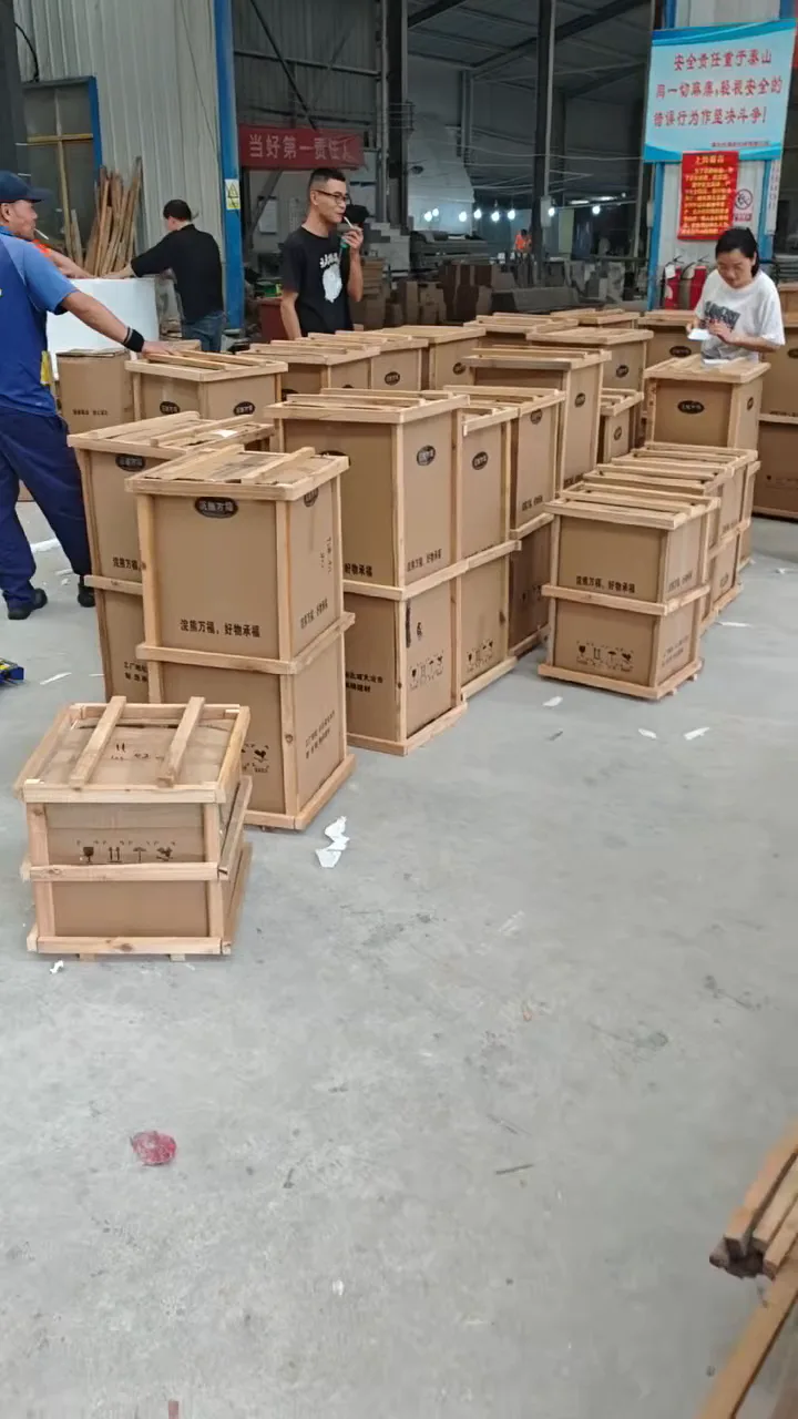Wood-framed packages on the workshop floor, still from the packaging and loading video