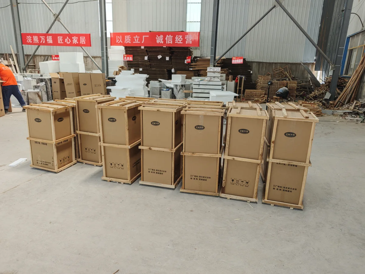 Rows of wood-framed cardboard packages on the floor of a workshop.
